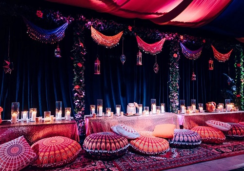 Arabian Nights theme party setting with hanging lanterns and draped fabrics