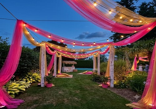 Goa theme party setting with beach shack decor and palm trees at sunset