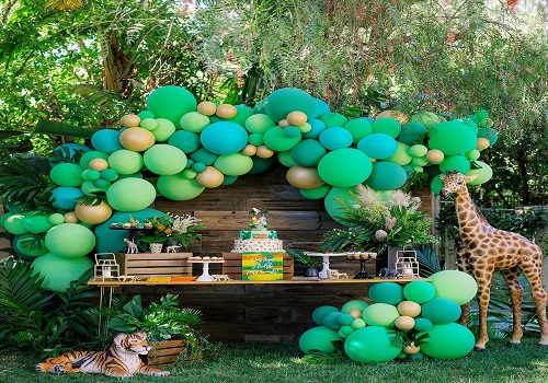 Jungle safari theme party with hanging vines and animal print decorations