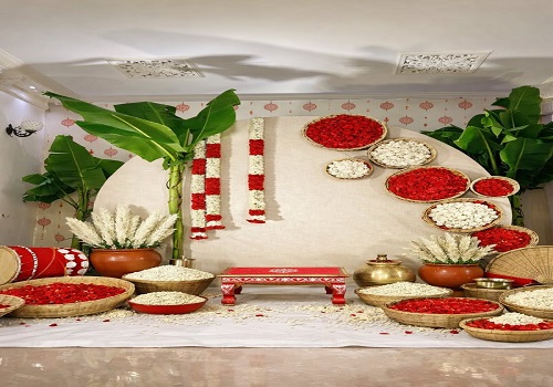 South Indian theme party decor with banana leaf backdrop and floral arch